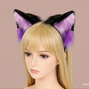 May include: A black headband with plush cat ears. The ears are black on the outside and feature a gradient of purple to pink on the inside. The ears are made of a soft, furry material.