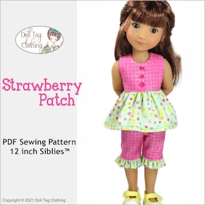 May include: A PDF sewing pattern for a 12 inch doll outfit. The outfit is a pink and green sleeveless top with a ruffled skirt and matching pink shorts. The doll is wearing the outfit and has brown hair.