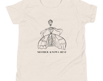 May include: A white t-shirt with a black line drawing of a woman in a dress. The text "MOTHER KNOWS BEST" is printed below the drawing.