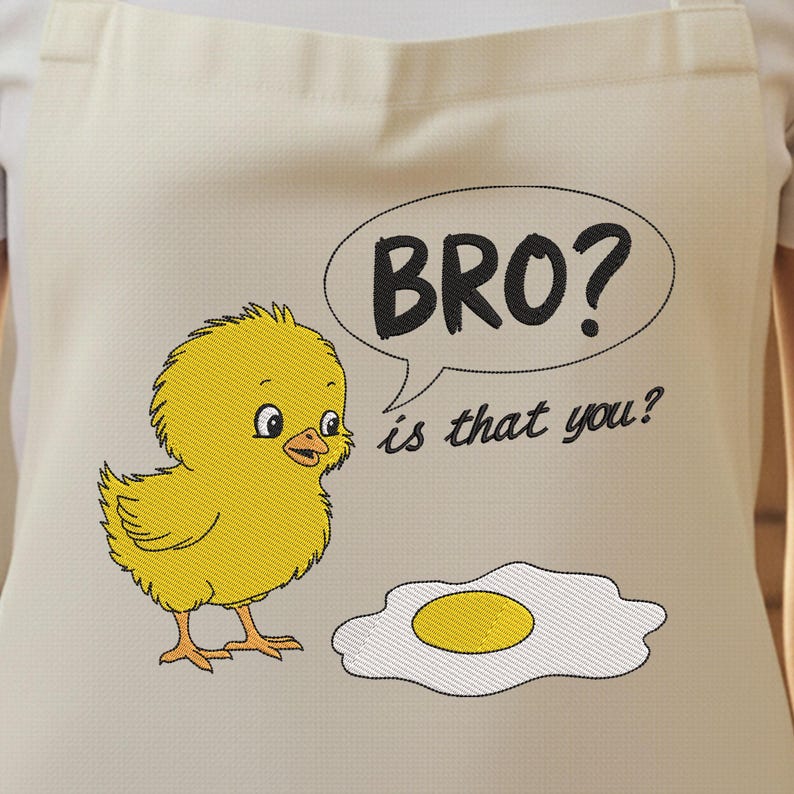May include: Off-white apron featuring a yellow chick embroidered next to a fried egg. A speech bubble with the text "BRO? is that you?" is above the egg. The chick has a surprised expression.