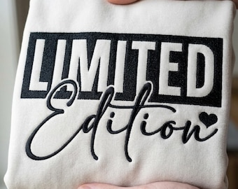 May include: Cream-colored sweatshirt with the words "LIMITED Edition" embroidered in black. The word "LIMITED" is in a bold, block font, while "Edition" is in a cursive script with a heart symbol.