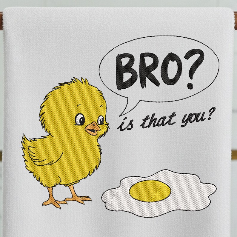 May include: White towel with an embroidered design featuring a yellow chick, a fried egg, and a speech bubble with the text "BRO? is that you?". The chick is looking at the egg with a curious expression.