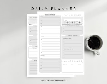 May include: A stack of gray and white daily planner sheets with the words "DAILY PLANNER" at the top. The planner includes sections for hourly schedules, to-do lists, and notes. A white mug filled with dark liquid sits to the right.
