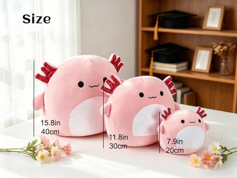 May include: Three pink axolotl plush toys of varying sizes. The largest is 15.8 inches (40cm) tall, the middle one is 11.8 inches (30cm), and the smallest is 7.9 inches (20cm). Each has a white belly, red gills, and a smiling face.