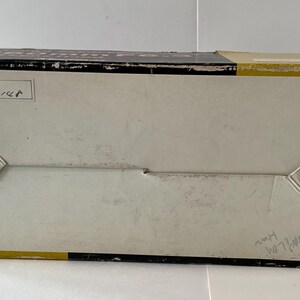 May include: A rectangular cardboard box with a black, white, and yellow color scheme. The top panel features the text "Lens No. 10148" in a white box. The bottom right corner includes the text "Made in Japan" and handwritten markings.