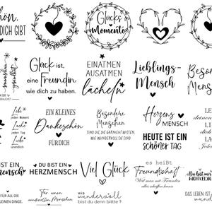 May include: A selection of black and white graphic designs featuring motivational quotes and phrases. The designs incorporate hearts, floral wreaths, and diverse fonts. Text includes phrases such as "Glücksmomente" and "Lieblingsmensch."