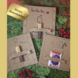 May include: Three festive Christmas cards on a bed of greenery. Each card is brown with a different holiday design: a candle, a Christmas tree, and a snowman. Each card has a banner with text and a small treat attached.