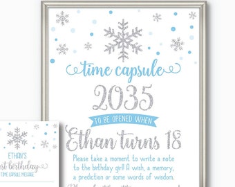 May include: A framed time capsule sign and matching cards with snowflake accents. The sign reads "time capsule 2035 to be opened when Ethan turns 18." Includes space for notes and signatures. A printable PDF file.