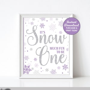 May include: Printable sign for a first birthday party with a winter theme. The sign is white with purple and silver snowflakes and says "It's Snow One" with the word "Snow" in silver glitter font. The sign is framed in a white frame and has a purple circle with the text "Instant Download Purchase & Print Today".