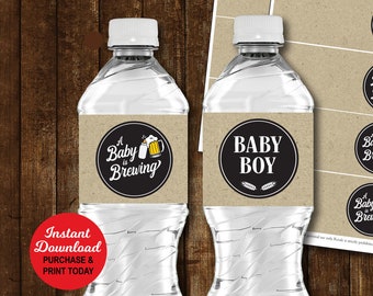 May include: Two water bottles with labels that read "Baby Boy" and "A Baby is Brewing". The image also shows printed sheets of labels with the same designs. The labels are brown with black and white text and graphics. The text "Instant Download" is also visible.