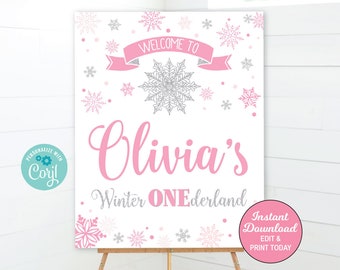 May include: A printable sign for a winter-themed first birthday party. The sign is pink and white with silver snowflakes and the text "Welcome to Olivia's Winter ONEderland".