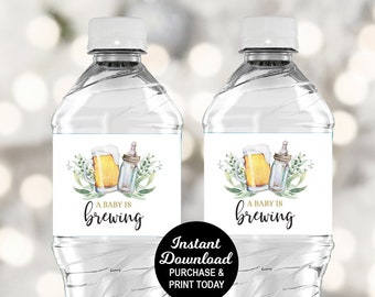 May include: Two clear plastic water bottles with labels that say "A baby is brewing". The labels feature a watercolor illustration of a beer mug and a baby bottle with green leaves.