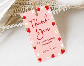 May include: A pink gift tag with a strawberry and flower design. The tag reads "Thank You" in red script, with the text "for making today so sweet!" and the names "Stephanie & Jason" below.