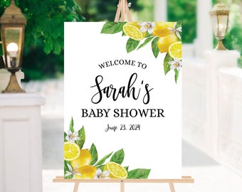 May include: White welcome sign with a lemon and floral design. The sign reads "Welcome to Sarah's Baby Shower June 23, 2024".