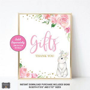 May include: A pink and white floral design with gold glitter accents. The text "Gifts" is written in pink cursive lettering. A white bunny with a floral crown is in the bottom right corner. The text "Thank You" is below the word "Gifts". The text "Sold Separately" is in a white circle with a pink border. The text "Link in Item Details" is below the text "Sold Separately". The text "Instant Download! Purchase Includes Signs in both 8"x10" and 5"x7" sizes" is at the bottom of the image.