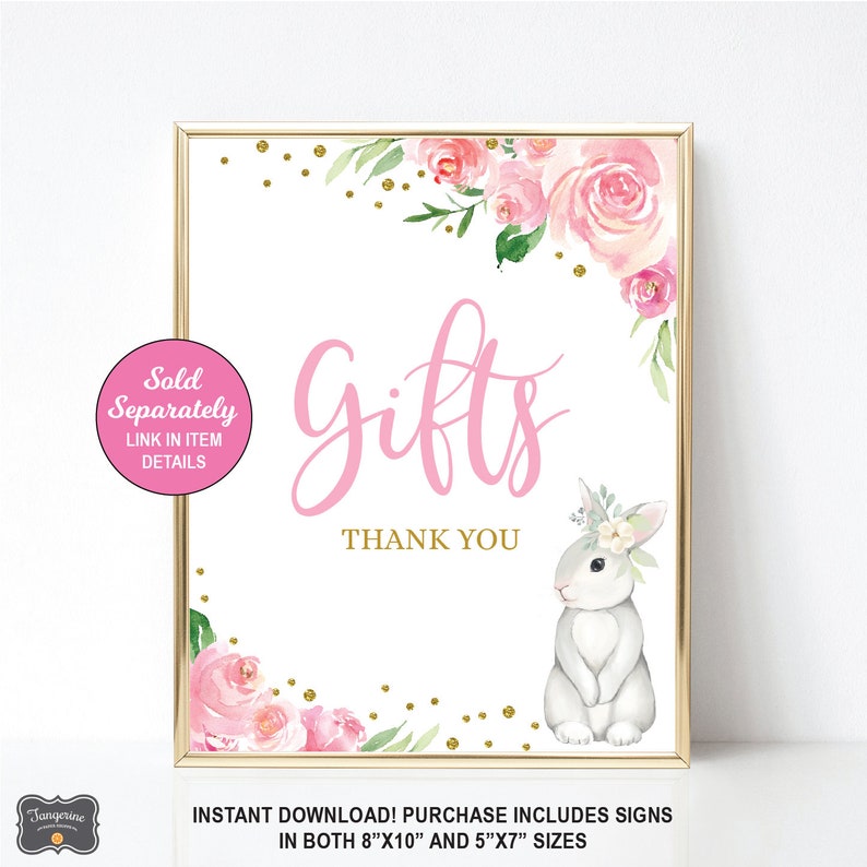 May include: A pink and white floral design with gold glitter accents. The text "Gifts" is written in pink cursive lettering. A white bunny with a floral crown is in the bottom right corner. The text "Thank You" is below the word "Gifts". The text "Sold Separately" is in a white circle with a pink border. The text "Link in Item Details" is below the text "Sold Separately". The text "Instant Download! Purchase Includes Signs in both 8"x10" and 5"x7" sizes" is at the bottom of the image.