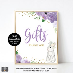 May include: Purple and green floral printable sign with a white bunny rabbit and gold glitter. The sign says "Gifts Thank You".