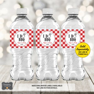 May include: Three clear plastic water bottles with red and white checkered labels that say "I DO BBQ" with a ring and a date. The labels also include the names "Alyssa & Johnny".