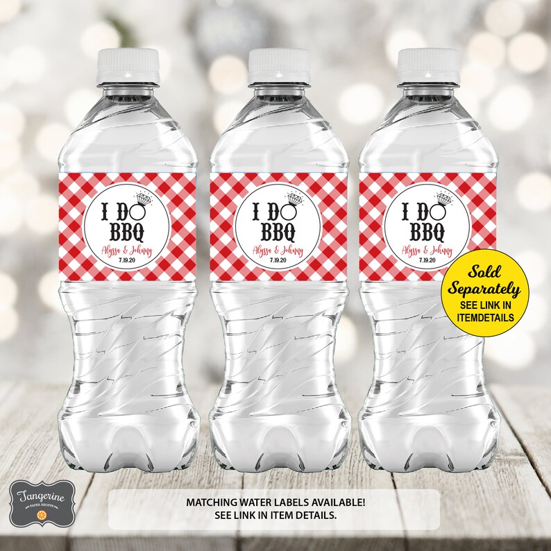 May include: Three clear plastic water bottles with red and white checkered labels that say "I DO BBQ" with a ring and a date. The labels also include the names "Alyssa & Johnny".