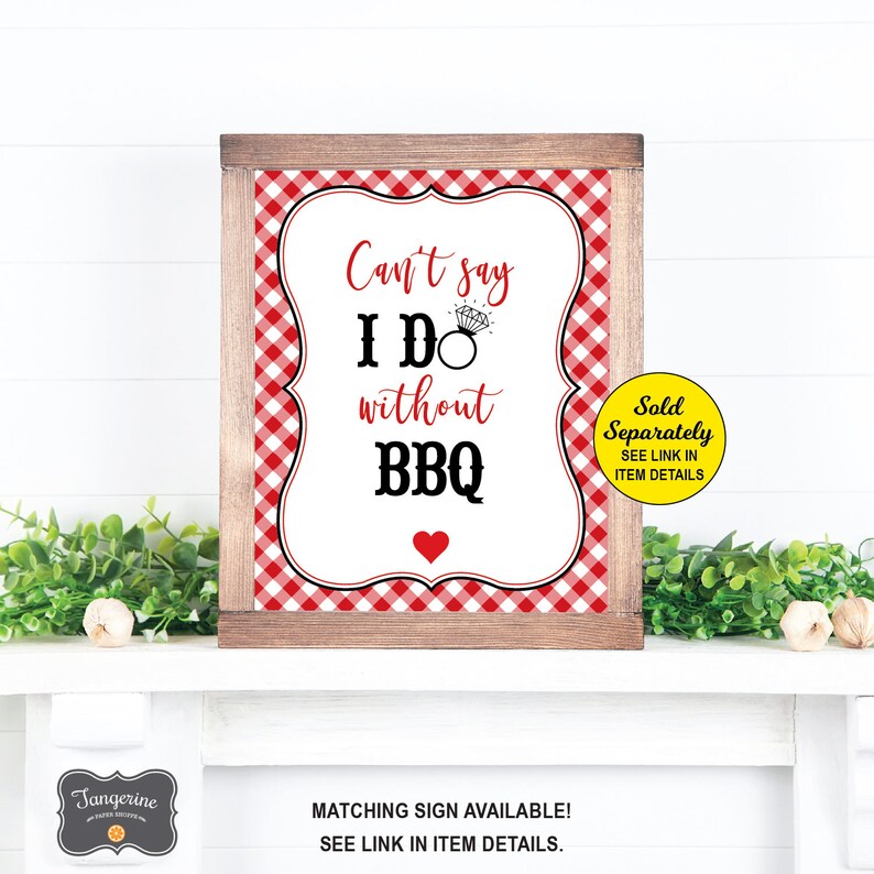 May include: A white sign with a red and white gingham border in a wooden frame. The sign reads "Can't say I DO without BBQ" with a diamond ring icon and a red heart. The sign also says "Sold Separately, SEE LINK IN ITEM DETAILS".