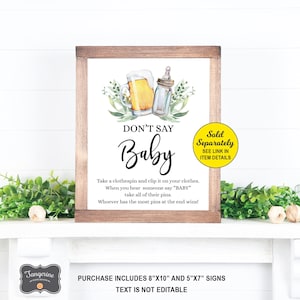 May include: A printable sign for a baby shower party game. The sign is in a wooden frame and has a white background with green leaves, a beer mug, and a baby bottle. The text on the sign reads "Don't Say Baby" and includes instructions for the game. The sign is sold separately in two sizes: 8" x 10" and 5" x 7".