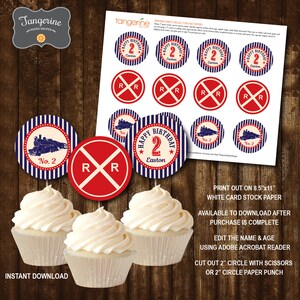 May include: Printable 2 inch round cupcake toppers featuring a red and white railroad crossing sign, a blue and white striped train engine, and a blue and white striped circle with the text "Happy Birthday 2 Easton".