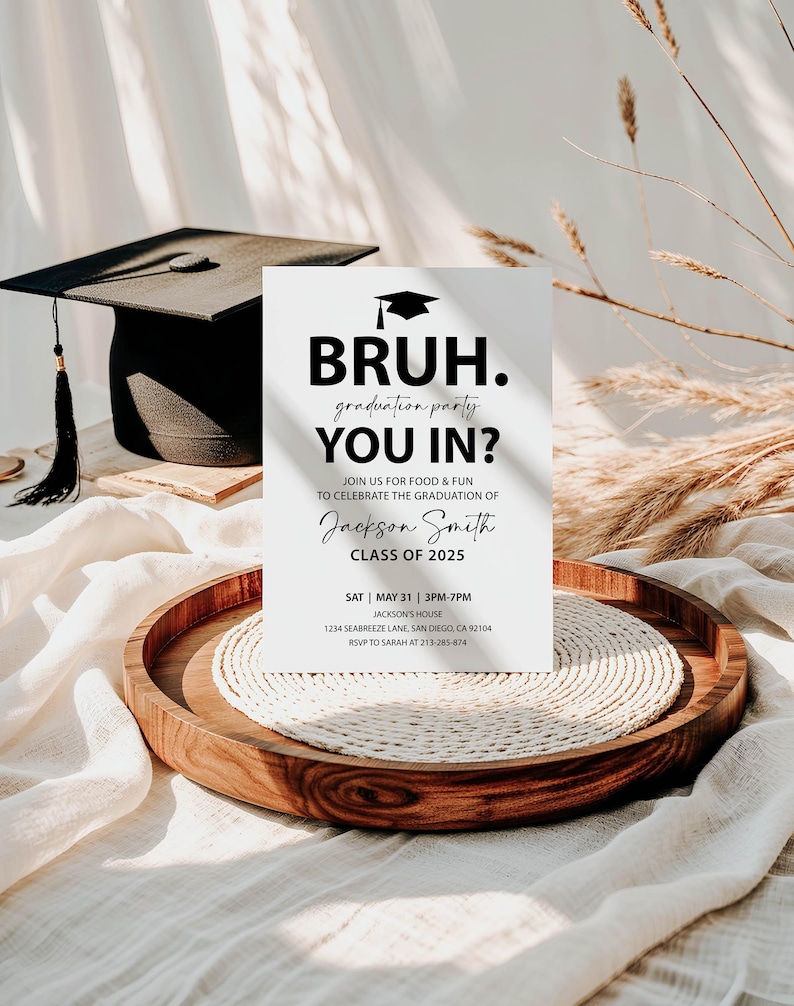 White invitation with clean modern black text. Black graduate cap is at the top then large BRUH. Cursive font under says graduate party under that large sans serif bold font says YOU IN? Under smaller says join us for food & fun to celebrate the graduation of graduate's name class of 2025. Party information is at the bottom.