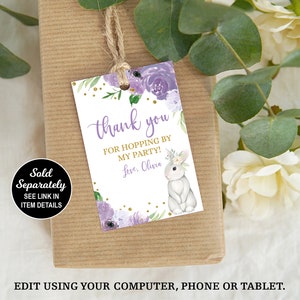 May include: Purple and gold thank you favor tag with a white bunny and floral design. The tag says "Thank you for hopping by my party! Love, Olivia."