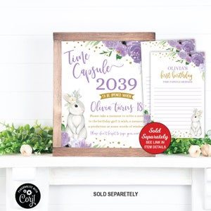 May include: A printable time capsule sign with a purple and gold floral design. The sign says "Time Capsule 2039 To Be Opened When Olivia Turns 18". There is a cute bunny rabbit illustration on the sign.