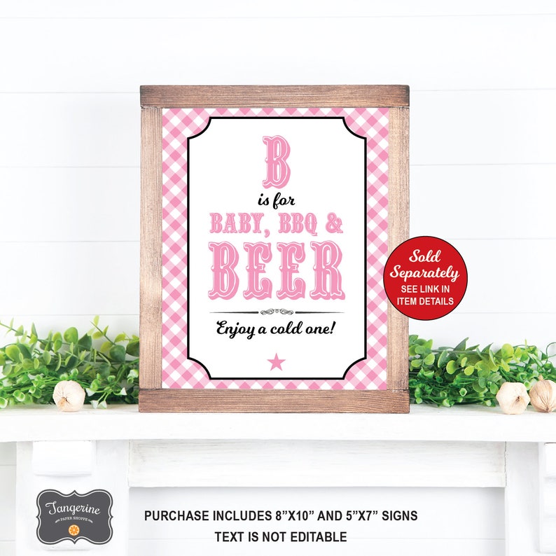 May include: Pink and white gingham patterned printable sign with the text "B is for BABY, BBQ & BEER. Enjoy a cold one!"  The sign is framed in brown wood.  The text "Sold Separately. SEE LINK IN ITEM DETAILS" is in a red circle on the right side of the sign.