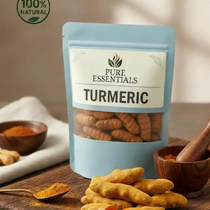 May include: A light blue pouch of turmeric with a clear window, labeled "PURE ESSENTIALS TURMERIC." Whole turmeric roots and powder are displayed on a wooden cutting board. A spoon holds turmeric powder, and the label reads "100% NATURAL."