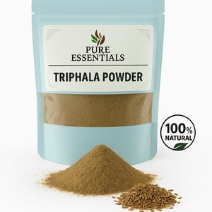 May include: A light blue pouch labelled "Pure Essentials" containing Triphala Powder. A pile of brown powder and seeds are in front of the pouch. A circular sticker reads "100% Natural".