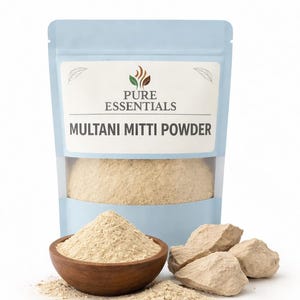 May include: A light blue pouch of Multani Mitti Powder from Pure Essentials. The pouch has a clear window showing the powder inside. A wooden bowl filled with powder and a few chunks of the clay are in front of the pouch.