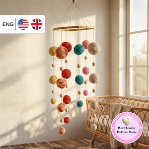May include: A colorful, handmade baby mobile featuring crochet spheres in various sizes and colors, including red, yellow, teal, pink, and beige. The spheres are suspended from a wooden ring with wooden beads, creating a decorative nursery accent.
