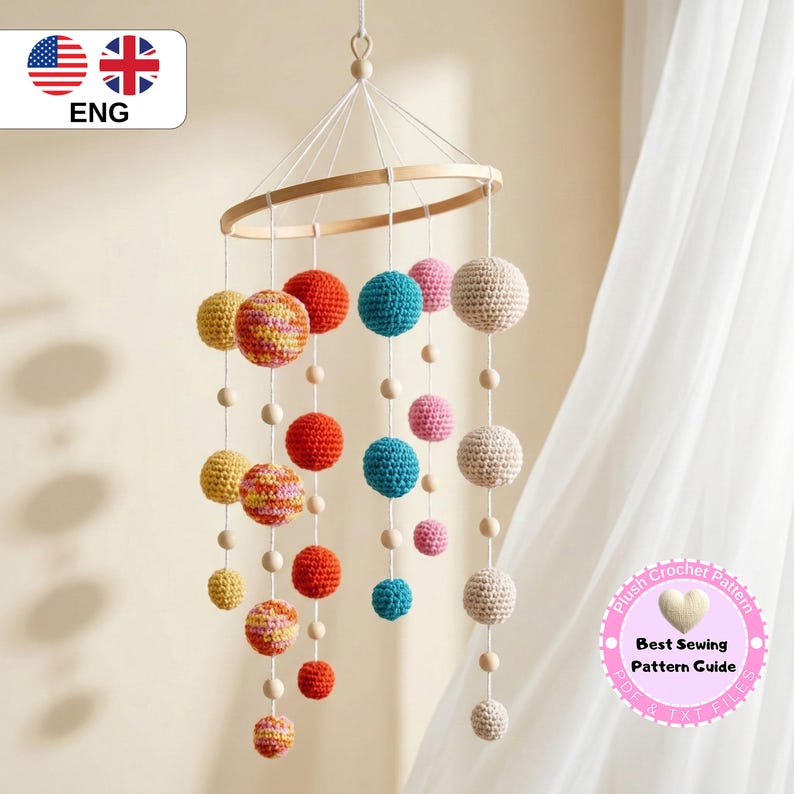 May include: A colorful crochet mobile with various sized spheres in shades of yellow, red, blue, and pink, suspended from a wooden ring. The mobile is designed for a nursery or children's room. The text in the image says "Best Sewing Pattern Guide".