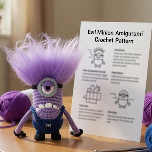 May include: A purple crocheted amigurumi figure with a single eye, wild purple hair, and blue overalls, standing next to a white instruction sheet titled Evil Minion Amigurumi Crochet Pattern, with purple and blue yarn balls nearby.