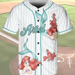 A white baseball jersey with the Disney character Ariel printed on it.