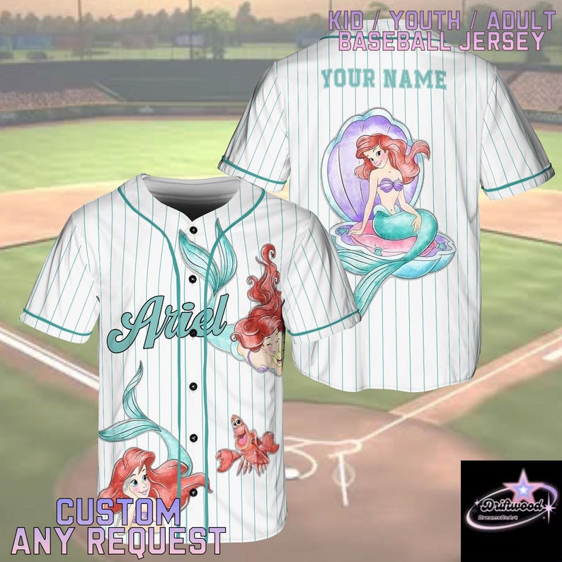 A personalized baseball jersey featuring the character Ariel from the Disney movie "The Little Mermaid". The jersey has a white background with stripes and illustrations of Ariel and other mermaid characters. The jersey is designed to be customized with a name and possibly other details.