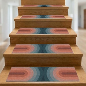 May include: Stair treads with a retro design. Each tread features concentric, semi-circular shapes in orange, red, teal, and grey. The treads are placed on wooden stairs, creating a visually appealing pattern.