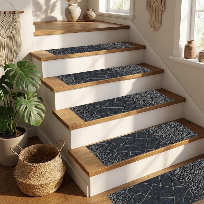 May include: A staircase featuring wooden steps and white risers. Each step is adorned with a dark blue runner, patterned with white abstract designs. The scene is complemented by a woven basket and a potted plant, enhancing the home decor.