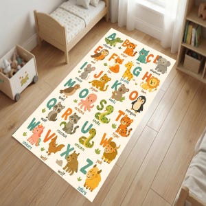 May include: A rectangular children's rug featuring the alphabet with colorful animal illustrations. Each letter is paired with an animal, such as an alligator for A, a cat for C, and a zebra for Z. The rug is beige with a playful design.
