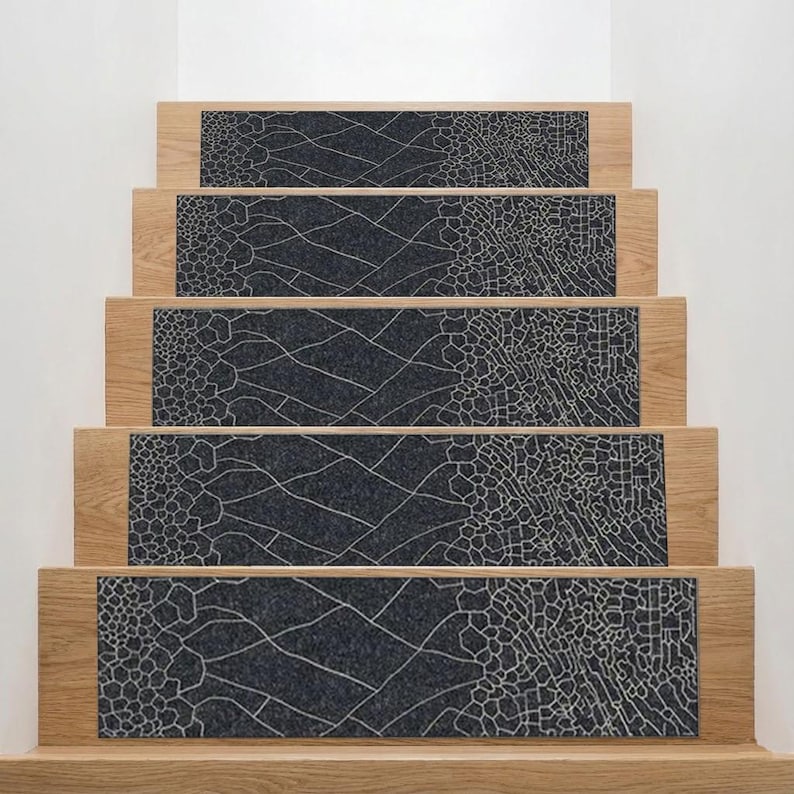 May include: Stair treads featuring a dark grey, textured pattern with light-coloured lines. The treads are set into light-coloured wooden steps, creating a modern look. The pattern resembles a cracked surface, adding a stylish touch to the home.