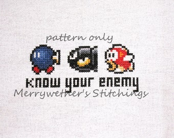 May include: Cross stitch pattern featuring three pixelated characters from the video game Super Mario Bros. The characters are a blue Koopa Troopa, a black Bob-omb, and a red Koopa Troopa. The text "know your enemy" is below the characters, and the text "Merrywether's Stitchings" is below that.