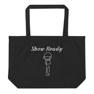 May include: Black tote bag with white text and a microphone graphic. The words "Show Ready" are written in a cursive font above a simple line drawing of a microphone.