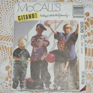 May include: A McCall's sewing pattern for children's clothing, featuring four boys wearing different outfits. The pattern number is 5608 and the size is CH (7, 8, 10). The pattern is titled "Gitano today's spirited family".