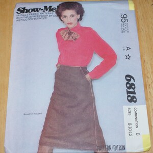 May include: A sewing pattern for a skirt, McCall's Show-Me! pattern number 6818, combination B, sizes 8-10-12. The pattern features a brown skirt with a brown belt and a red blouse with a brown bow.