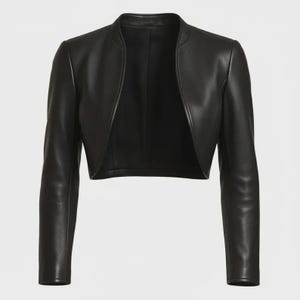 May include: A black cropped bolero jacket made of smooth material with long sleeves and a rounded open front design. The garment features a clean, collarless neckline and structured shoulders, providing a sleek, fitted silhouette that ends above the waist.