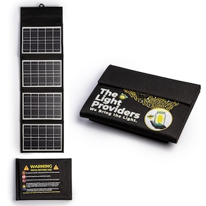 May include: A black foldable solar panel charger with four rectangular panels. The exterior features the text The Light Providers We Bring the Light and a graphic of a hand holding a glowing jar. A warning label is included with safety instructions.