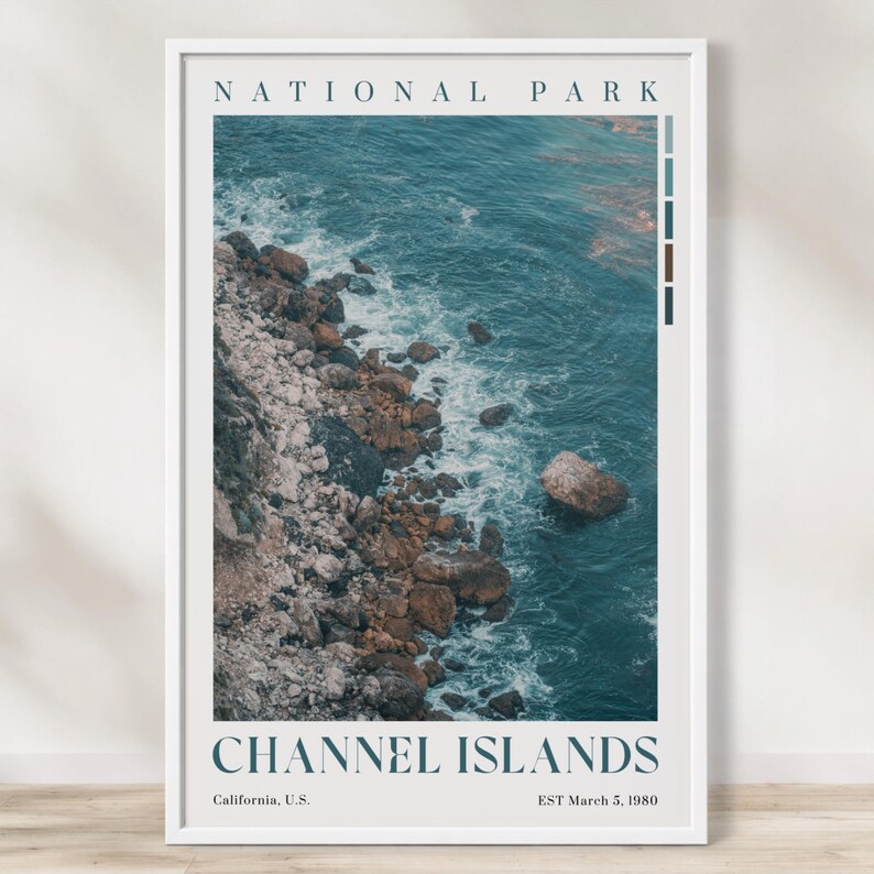 May include: A framed poster depicting the Channel Islands National Park. The photograph shows a rocky coastline meeting the turquoise ocean. The poster includes the text "NATIONAL PARK" at the top and "CHANNEL ISLANDS" at the bottom.