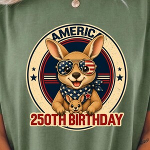 Cute patriotic kangaroo wearing American flag sunglasses shirt, America 250 shirt, funny animal tee, patriotic shirt, retro USA shirt, 4th of July shirt, vintage Americana animal graphic tee, USA 250 anniversary apparel, independence day shirt, animal graphic tee, summer patriotic outfit, funny patriotic animal shirt, freedom celebration shirt, fourth of july tee, cute kangaroo lover gift.